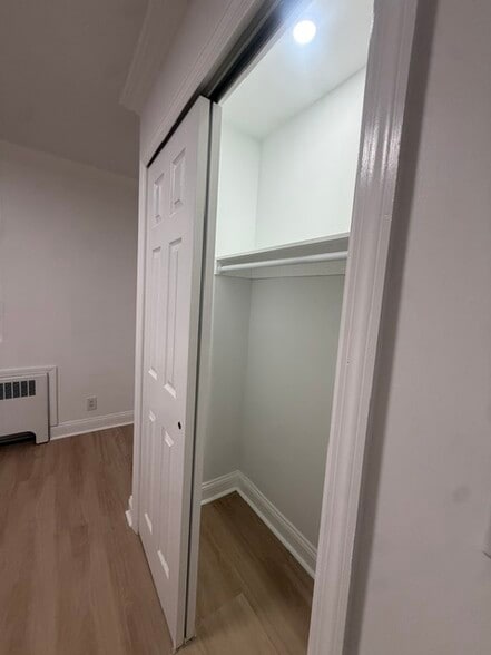 Spacious bedroom closet with built-in shelving & recessed lighting - 1120 50th St
