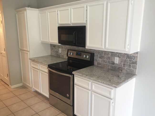 Kitchen which has indoor laundry room. - 7921 Pecan Dr