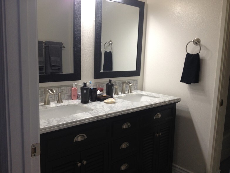 master bathroom vanity with marble countertop and espresso cabinet - 14572 Dickens St