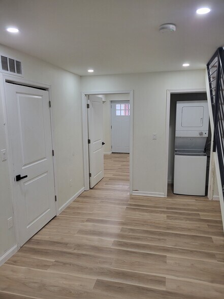 front of basement looking towards basement bedroom and backdoor - 1164 Atwood Rd