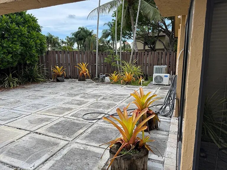 Backyard with the lake view plus mango and star fruit trees. - 13169 SW 91st Ct