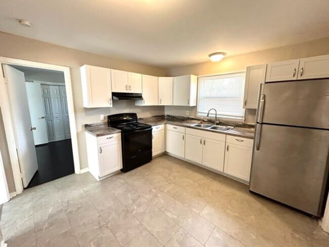 Building Photo - FOUR BEDROOM ONE AND HALF BATH BRICK RANCH HOME