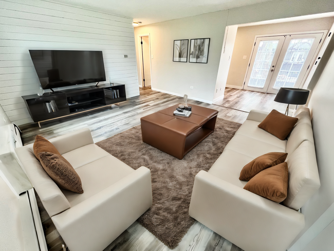 Experience modern comfort in this stylish living room, perfect for relaxation and entertainment. - OAK NORTH APTS