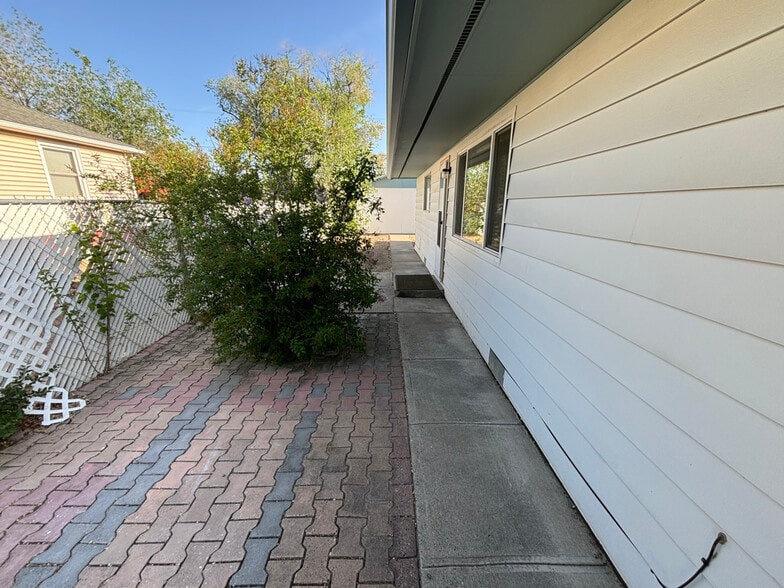 West facing side entrance with mature lilac bush. - 1718 White Ave