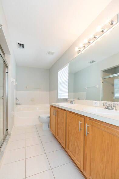 Master bathroom includes dual sinks, garden tub, and separate glassed in shower - 18135 Nassau Point Dr