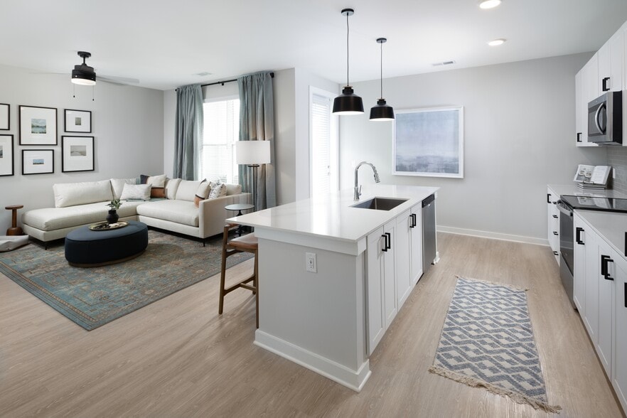 Kitchen, living, and dining areas with hard-surface vinyl plank flooring - Avalon Lake Norman