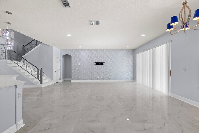 Building Photo - Spacious 6-Bedroom Home Near Lake Nona | 3-Car Garage + Tesla Charger