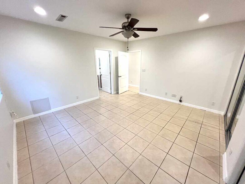 Primary bedroom (wide-angle) looking back at entrance & primary en-suite bathroom. - 2330 S Mansfield Ave