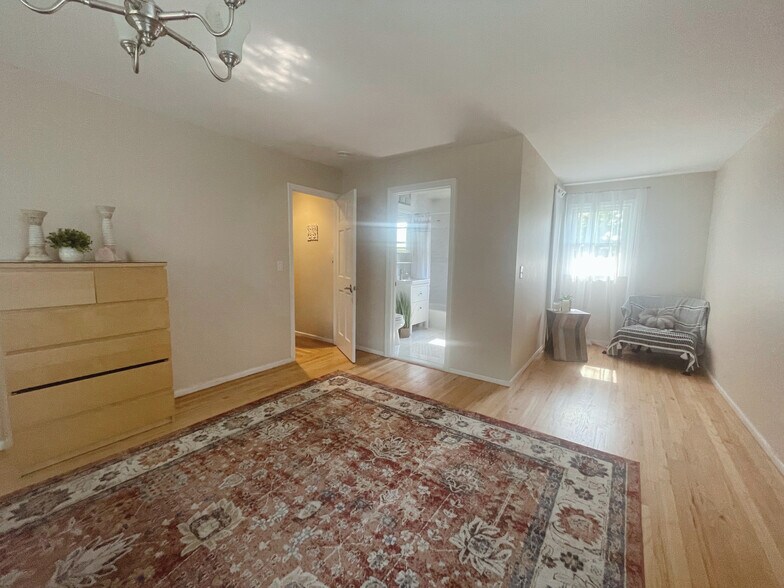 Master suite with a sitting area and a bathroom - 10 Lundy Ln
