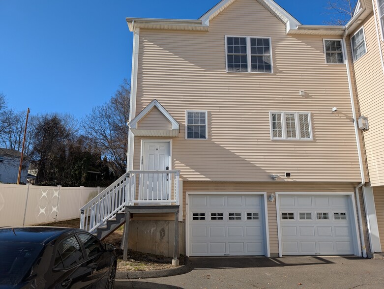 Exterior of Unit 100 with two car garage - 100 Castle Ave