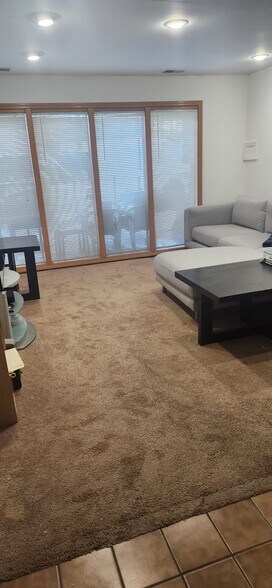 View#7 of downstairs livingroom with view of floor to ceiling windows - 2116 Thaler Ave