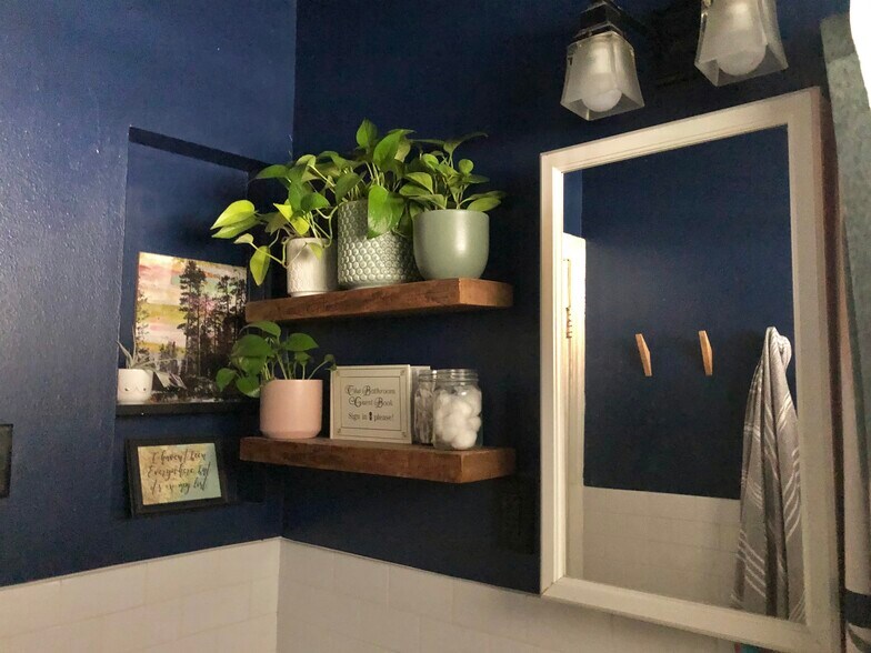Bathroom with updated blue paint and wooden floating shelves and towel hooks - 5715 Joe Sayers Ave