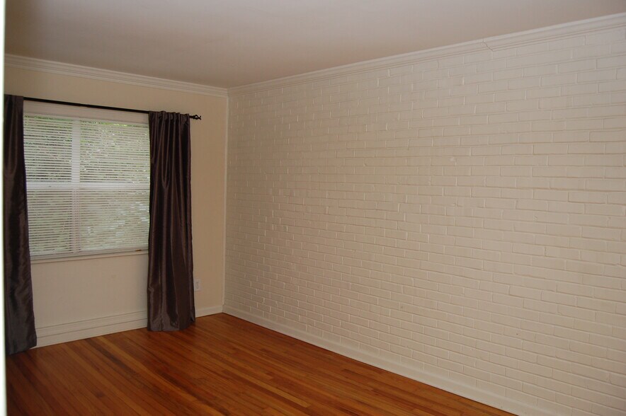 bedroom with brick wall - 5075 Fairmont Rd SE