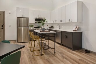 Chef-inspired kitchens feature stainless-steel appliances, sleek quartz countertops, and clean tile backsplashes. - Modera Berkeley Heights