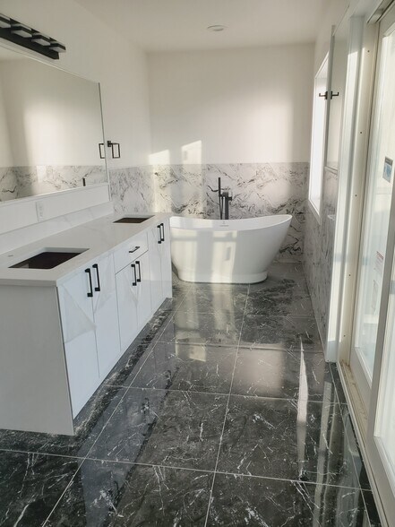 En-suite master bathroom with full size soaking tub, balcony , and shower. - 5541 Guide Meridian
