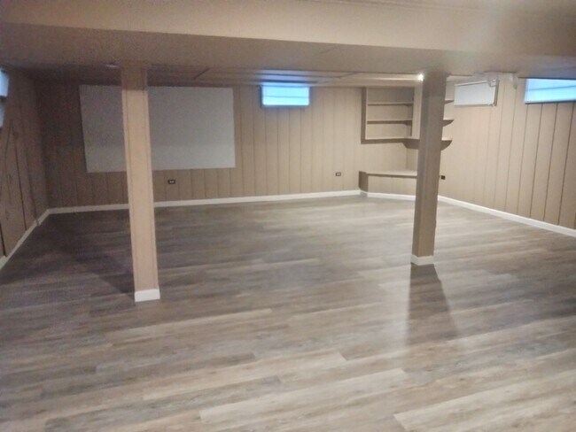 Basement with projector screen & new luxury vinyl plank flooring - 1004 Gould Rd
