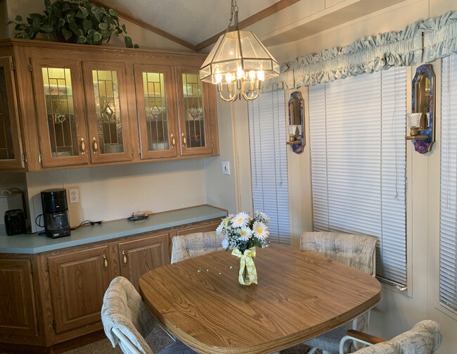 A convenient sideboard for the dining area with lovely lighted china cabinet - 11489 S Clara Anita Dr