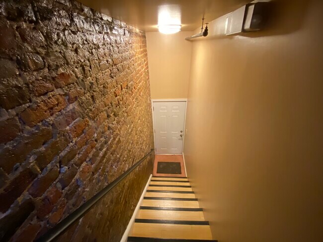 Home entrance with steps and exposed brick - 17 N 17th St