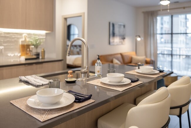 Stylish open-concept layout with kitchen island and inviting living space. - The Allison at Fenton