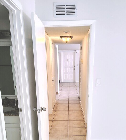Hallway with W/D on left, A/C and water heater on right - 1353 Pine Ridge Cir E