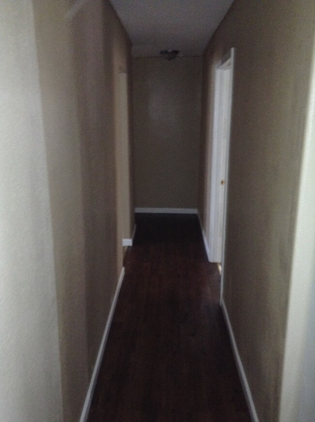 Hallway is between the living room to the left and the kitchen and master bedroom to the right. - 24 N K St