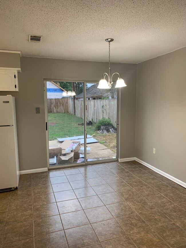Dining room with sliding back door. - 203 Club Ln