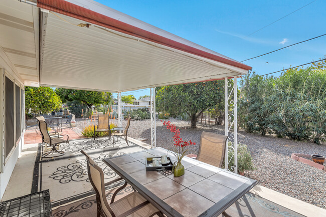 Large covered patio, gas grill, 2 patio table sets, abundant orange trees and a fully fenced yard. - 10113 W Pebble Beach Dr