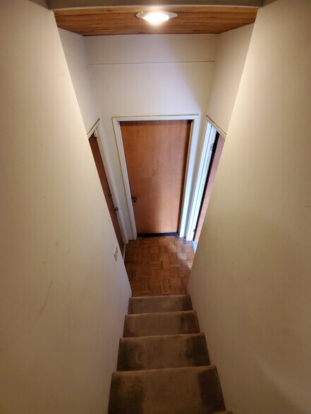 Downstairs leading to 2 bedrooms and patio access - 2635 Hollyridge Dr