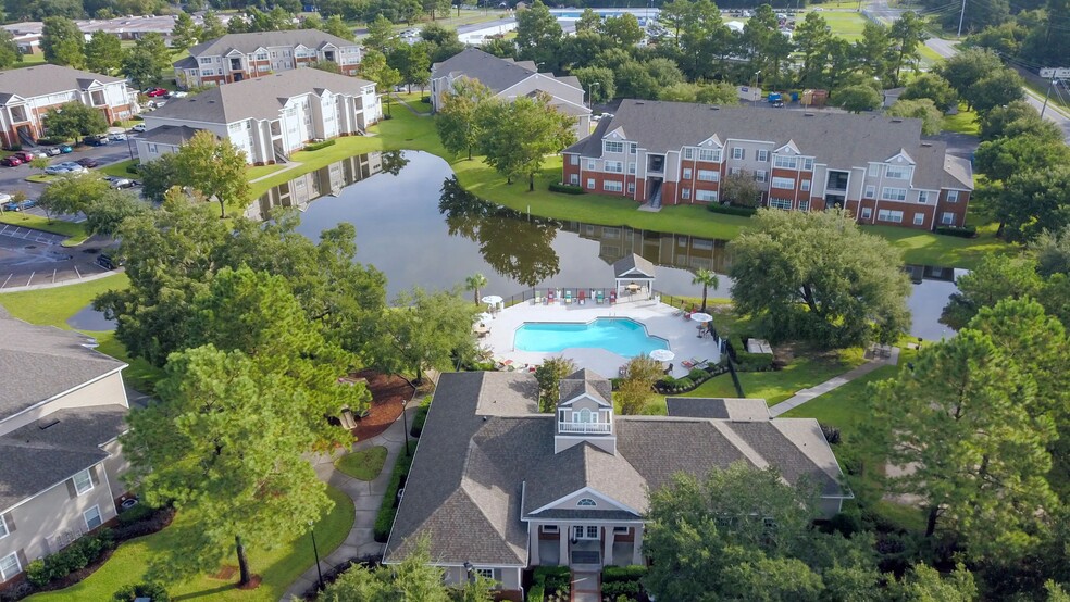 Savor the panoramic splendor of Eagle's Pointe in Brunswick, Georgia, from high above. An enchanting haven where the lake glistens, greenery flourishes, and a vibrant community thrives. - Eagles Pointe