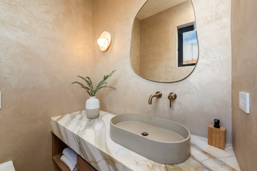 Elegant powder room with custom vanity, plaster walls, and a modern wall-hung toilet - 836 Waterloo St