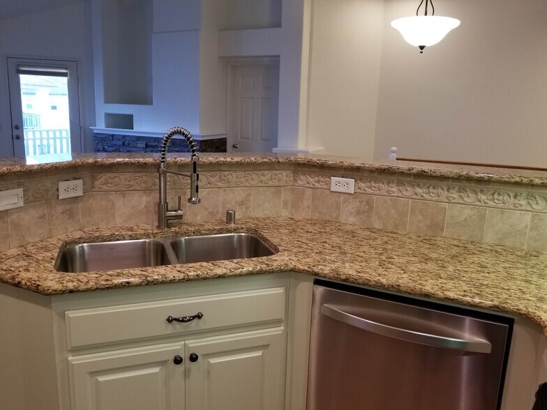 Kitchen with new modern commercial-style faucet and new Bosch dishwasher - 16939 Robins Nest Way