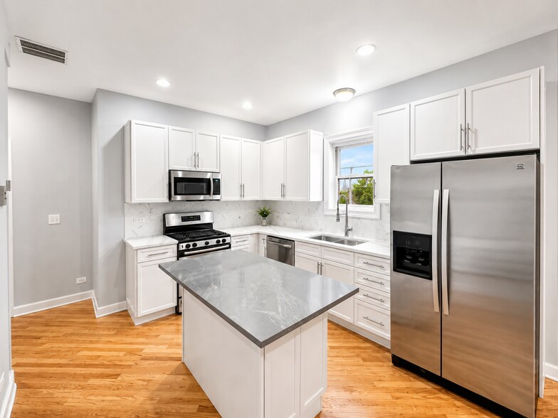 White updated kitchen with new quartz countertops - 3513 North Reta Avenue