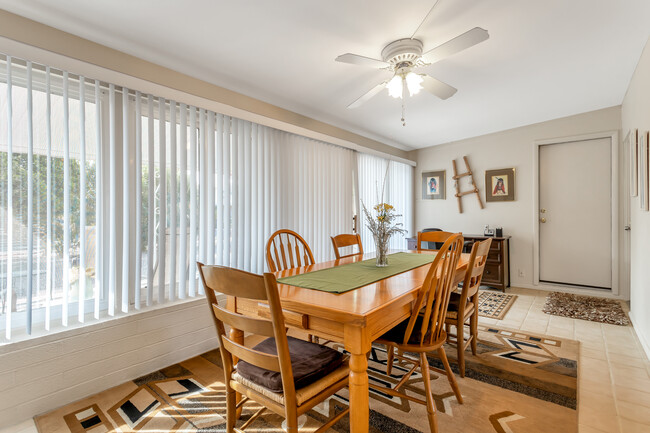 Large dining room with gorgeous large windows looking out to the back yard, and a desk with a view. - 10113 W Pebble Beach Dr