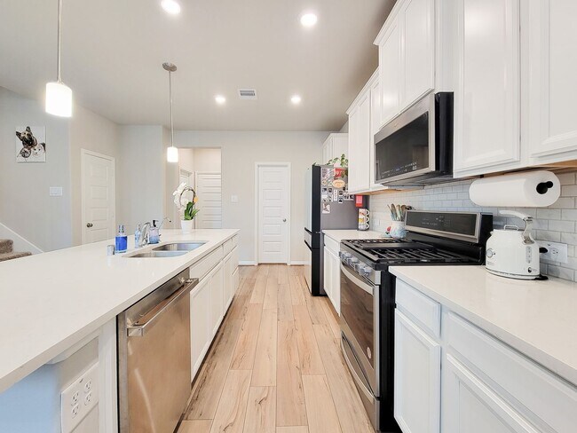 Building Photo - A true gem on a quiet corner lot, this spacious and sun-filled home is tucked away from street no...