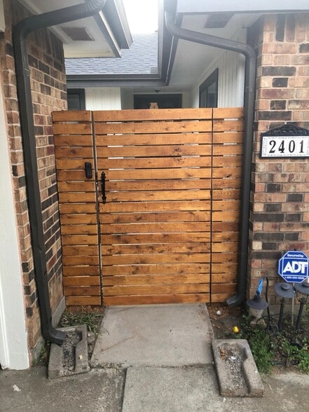Modern wood privacy gate with keypad lock — secure and stylish entrance to the home. - 2401 Thistle Ct