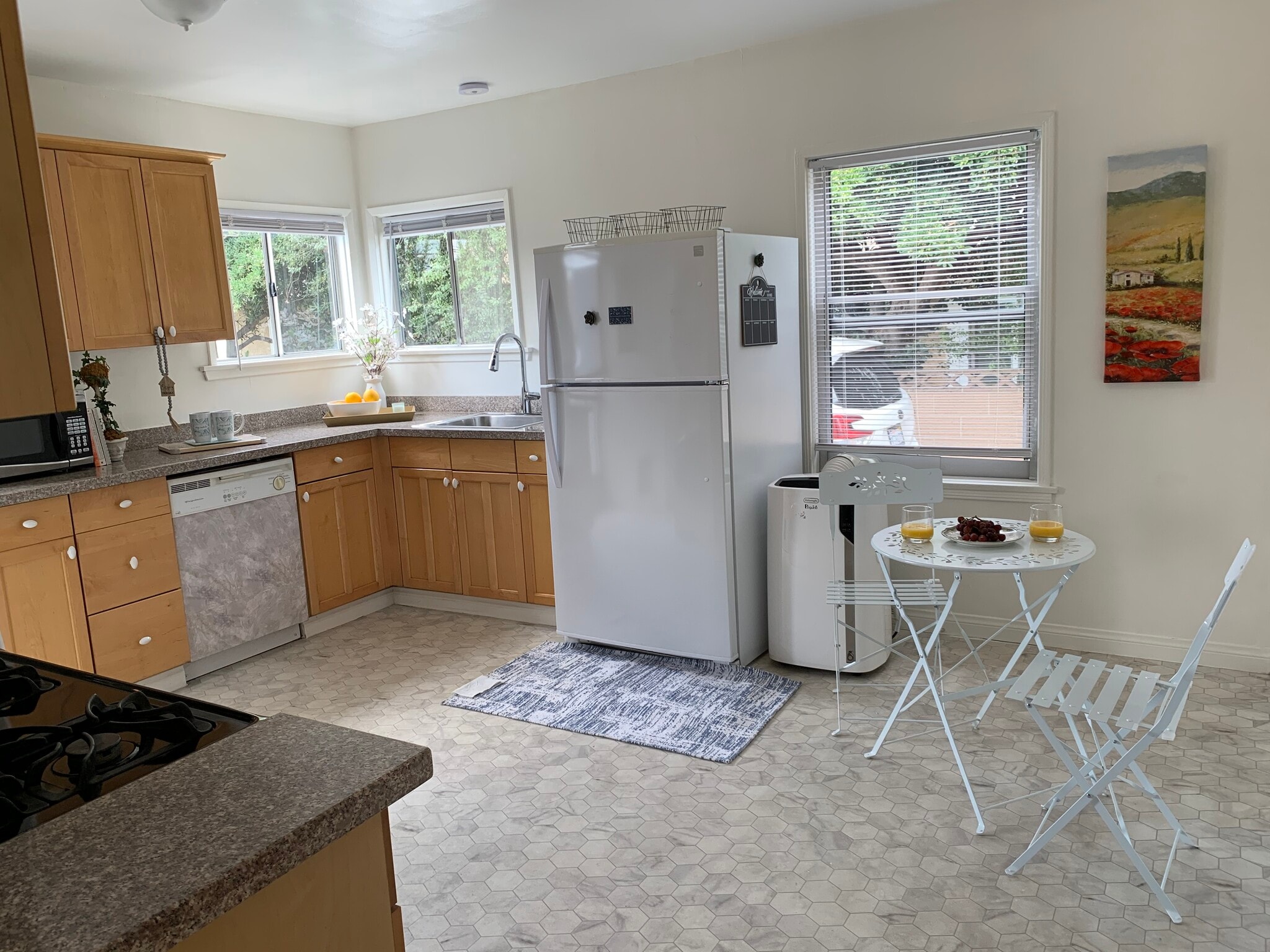 Kitchen equipped with washer, dryer, stove, dishwasher, and refrigerator - 4092 Howard Ave