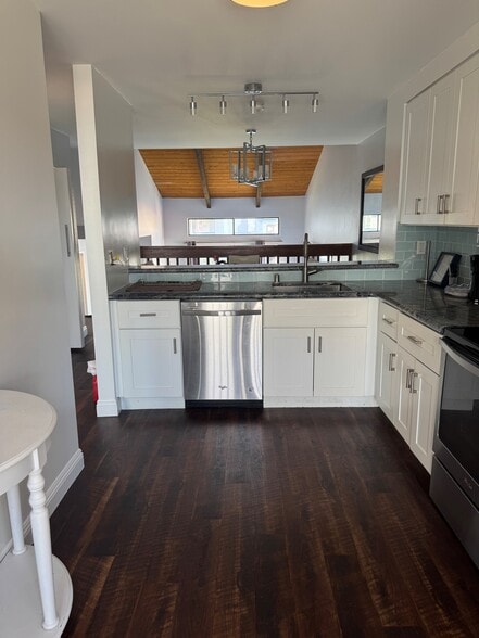kitchen with stainless steel appliances and white shaker cabinetry - 3412 Via Alicante