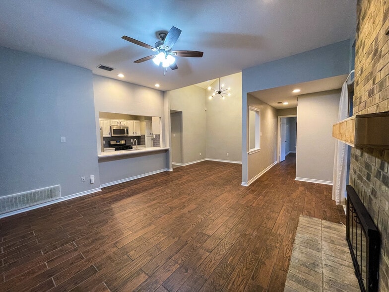 Open concept Kitchen, dining and living room. Features wood look tile throughout the home. scrapped ceilings, fresh interior paint, gas logs in the fire place and all new ceiling fans and light fixtures throughout. - 812 Via Madonna