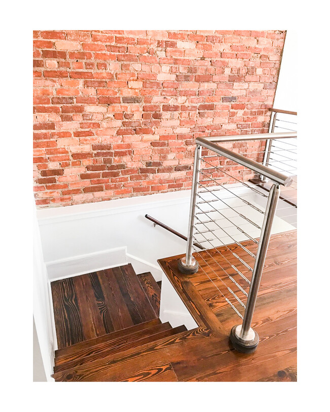 Modern handrail and beautiful exposed brick details. - 18 W State St