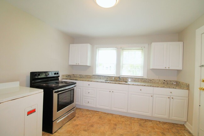 Building Photo - Charming home with updated Kitchen