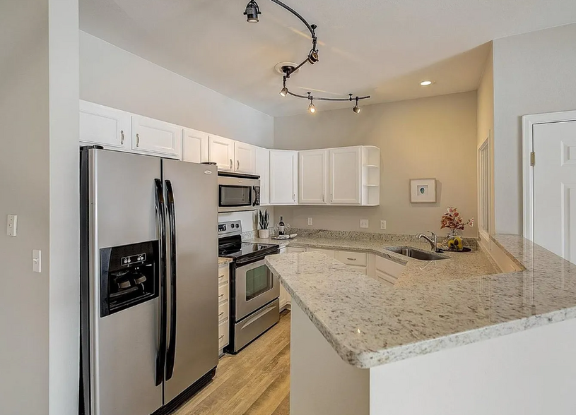 Open kitchen with granite countertops! - 10784 W 63rd Pl