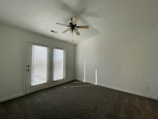 Master bedroom w/ French door balcony and vaulted ceiling - 9485 S Fairway View Dr