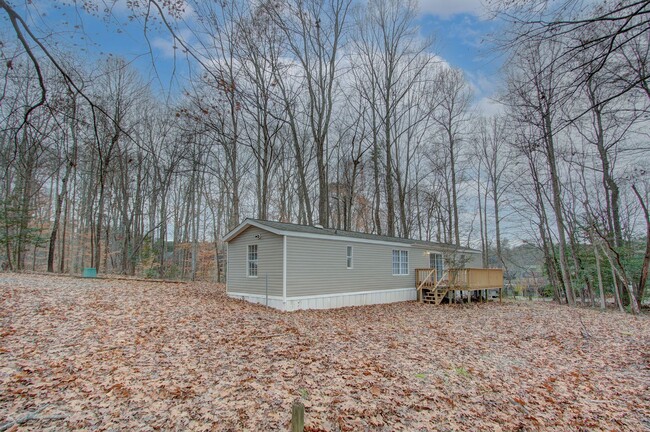 Building Photo - Nestled on a spacious, private wooded wate...