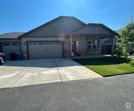 Building Photo - Single level, triple car garage and A/C!