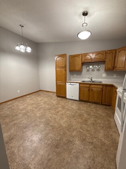 Spacious kitchen and dining area with updated lighting and plenty of room for a full table. - 9092 Goldenrod Ln N