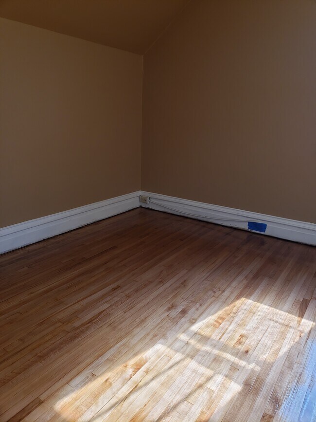 Bedroom #1: Floors completely refinished and fresh paint. - 522 N 42nd Ave W