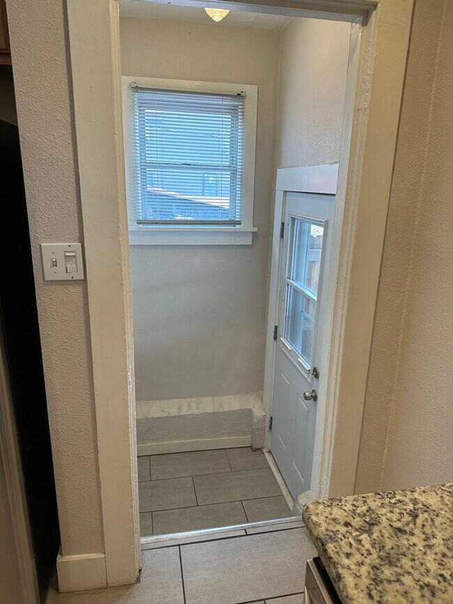 Back door and steps to basement. Storm door has a cat or small dog door - 3628 Mariposa St