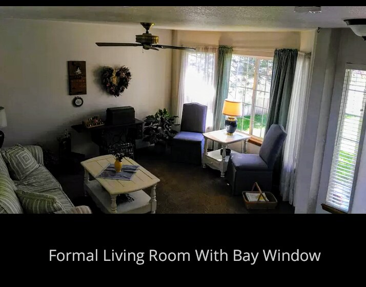 Front formal living room with bay windows - 6297 E 122nd Ave