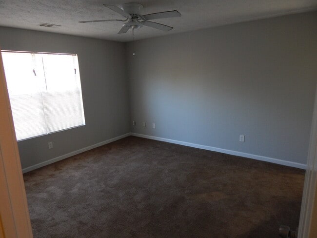 Building Photo - Freshly painted and new flooring in this 4 Bedroom 2 and Half Bath home. Covered front porch with...