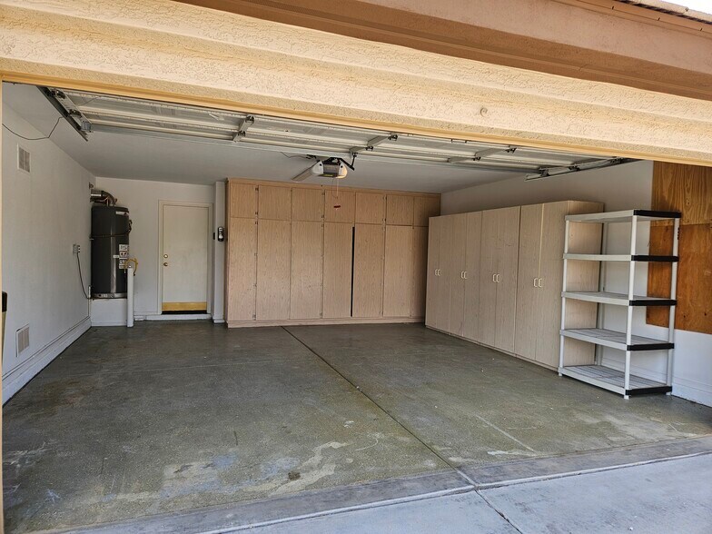 Two Car Garage w/storage cabinets - 20408 N 70th Dr